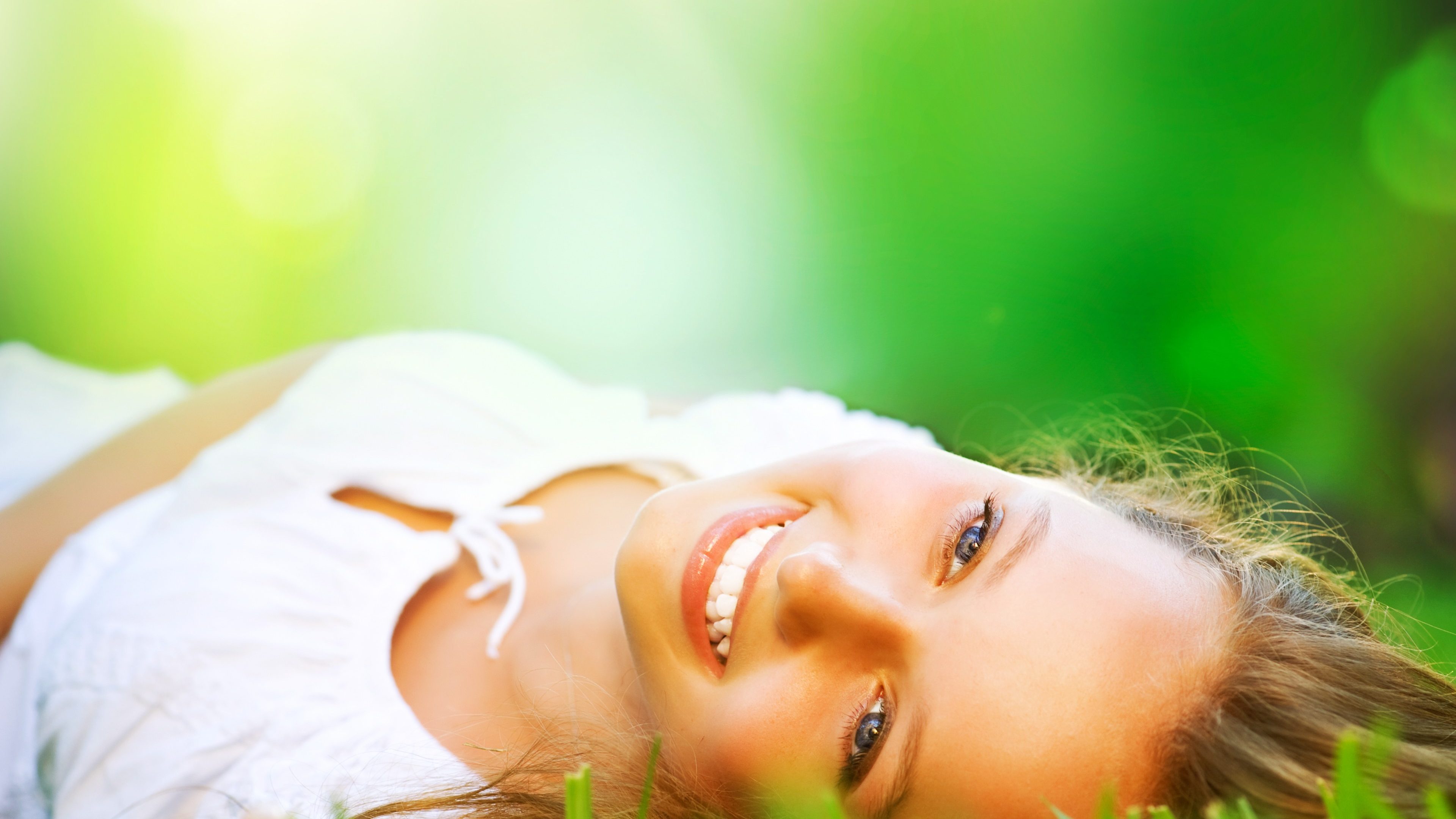 Spring Girl lying on the Field. Happiness