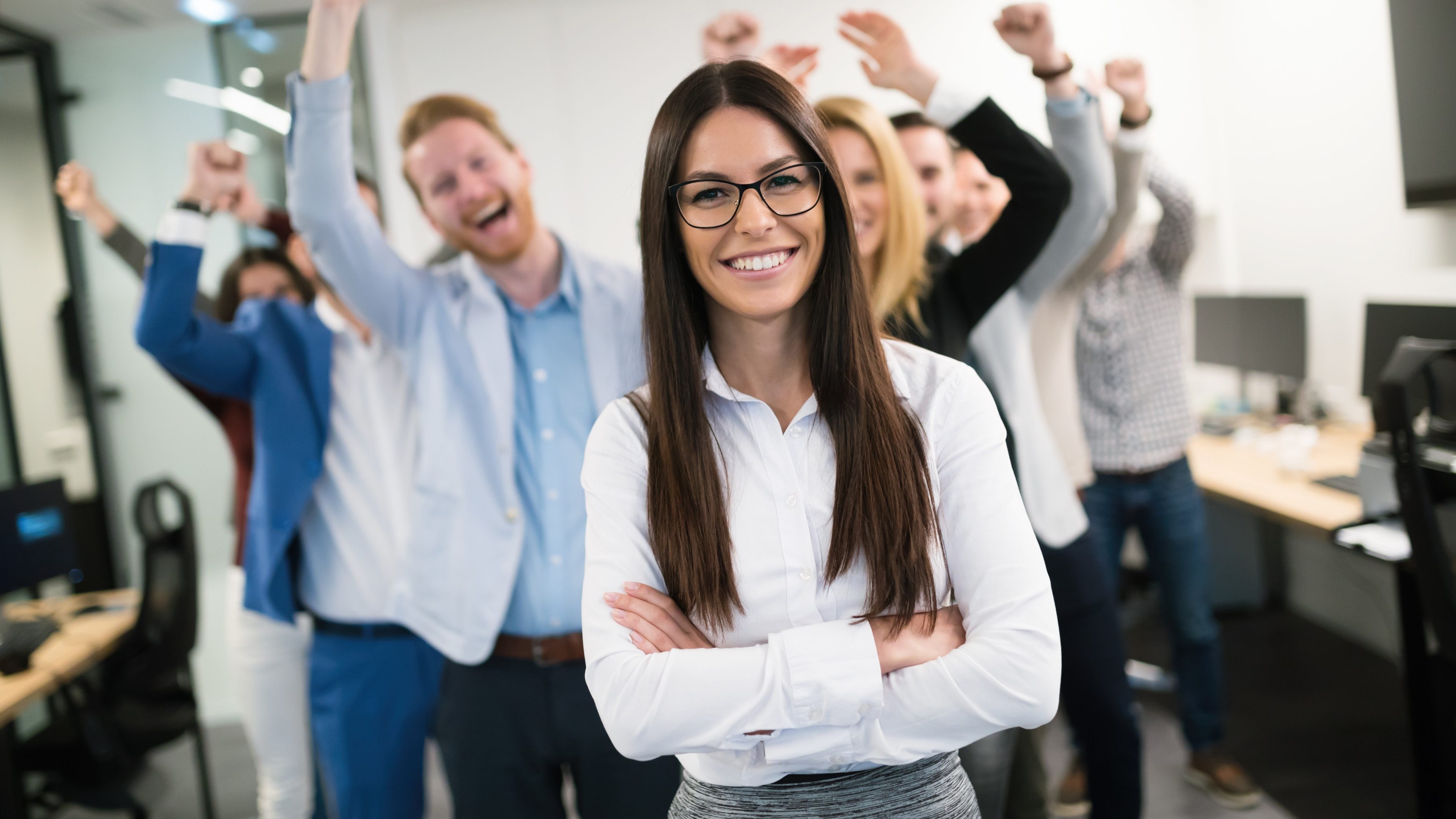 Happy business people celebrating success at company